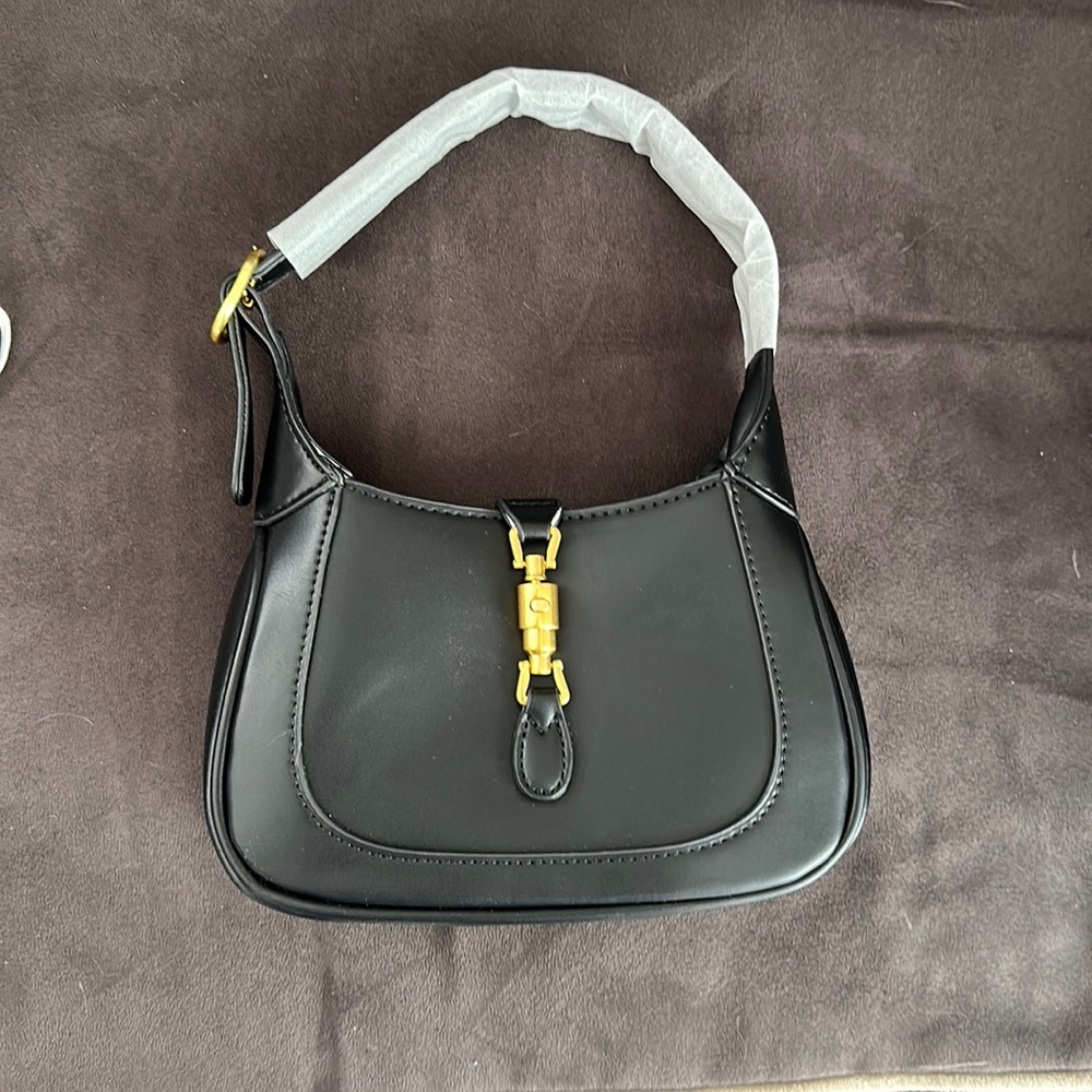 Mini Black Purse with shoulder strap as well. Never used.